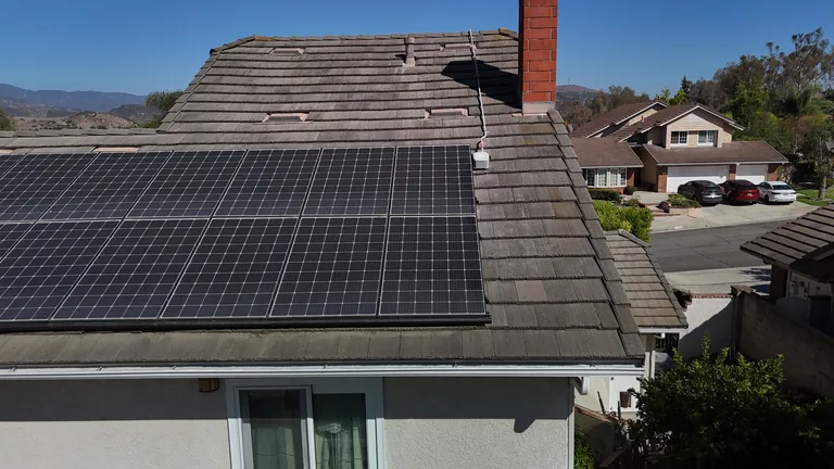 Aerial view of a residential solar panel installation showing panel spacing and conduit run